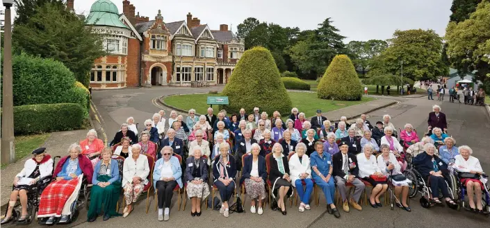  ??  ?? In the spotlight: The women and men who worked at Bletchley Park gather in front of the site to mark the 80th anniversar­y of the start of the Second World War