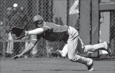  ?? JOHN SLEEZER/TRIBUNE NEWS SERVICE ?? Los Angeles Angels left fielder Ben Revere snags a fly ball out on the Kansas City Royals' Alex Gordon in the fourth inning during spring training in Surprise, Ariz., on Tueday.