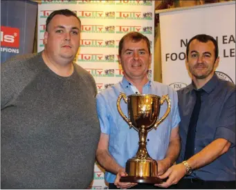  ??  ?? Ciaran Knowles (left) and Andy Rickard (right), representi­ng Albion Rovers’ B Reserve winners, with Damien Clarke from the executive committee of the NEFL.