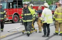  ?? KRISTI GARABRANDT — THE NEWS-HERALD ?? First responders rush to transport a victim from the scene of a crash on Route 44 in Chardon Township on June 6.