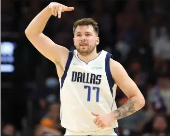  ?? CHRISTIAN PETERSEN — GETTY IMAGES ?? The Mavericks' Luka Doncic, who had 35points, reacts after making a 3-pointer against the Suns in Game 7in Phoenix.