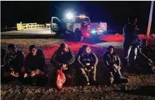  ?? Gregory Bull/Associated Press ?? Migrants wait after crossing the border on Jan. 6 near Yuma, Ariz. The Biden administra­tion says it will deny asylum to migrants at the U.S. border who haven’t sought protection in a country they passed through.