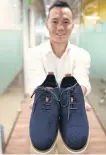  ??  ?? Le Thanh, managing director of ShoeX, shows off shoes made with fibre from coffee grounds at his co-working space in Ho Chi Minh City.