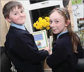  ??  ?? Pupils from Scoil Naomh Treasa in Bellewstow­n at the launch of their cookbook.