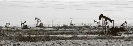  ?? Jeri Clausing / Associated Press ?? Oil rigs stand in the Loco Hills field on U.S. 82 in Eddy County near Artesia, N.M., one of the most active regions of the Permian Basin.