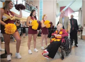  ??  ?? Loyola cheerleade­rs greet Sister Jean as she enters the Damen Student Center.