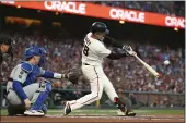  ?? JED JACOBSOHN — THE ASSOCIATED PRESS ?? San Francisco Giants’ Buster Posey hits a double in front of Los Angeles Dodgers catcher Will Smith during the first inning of Game 5of a baseball National League Division Series Thursday in San Francisco.
