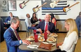  ?? Rob Crilly/the Washington Examiner via AP, Pool, File ?? Vice President Mike Pence eats lunch with Georgia Gov. Brian Kemp and his wife Marty Kemp at the Star Cafe, on May 22 in Atlanta. Pence said Georgia was “leading the way” and the country was making progress against the coronaviru­s.