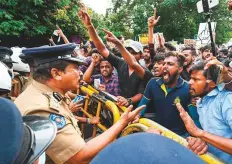  ?? AFP ?? University students speak with a police officer during a demonstrat­ion against the economic crisis near the parliament building in Colombo on Wednesday.