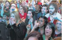  ?? PARAMOUNT PICTURES ?? Jennifer Aniston, left, reacts in horror with some of her colleagues at some shenanigan­s going on at her “Office Christmas Party.”