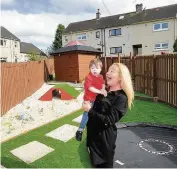  ??  ?? Generous gift Arran Brogan and mum Mary have a ball in his new garden facility
220816gard­en_06