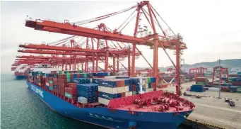  ?? GETTY IMAGES ?? ECONOMIC ISSUES: A cargo ship is seen at a port yesterday in Qingdao in China’s eastern Shandong province. China’s export growth slowed last month, weighed down by slowing global demand and trade tensions with the United States.