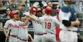  ?? TED S. WARREN — THE ASSOCIATED PRESS ?? The Phillies’ Tommy Joseph is greeted at the dugout after he hit a solo home run to lead off the ninth inning in Seattle Wednesday, tying the game. The Phillies would tack on one more run in the inning and win 5-4, sweeping a two-game set with the...