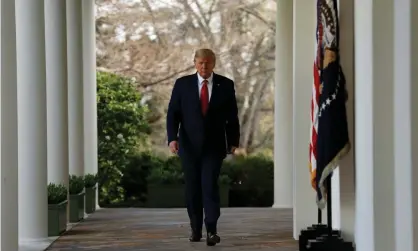  ??  ?? Donald Trump walks along the Colonnade at the White House on 29 March 2020. Photograph: Stefani Reynolds/EPA