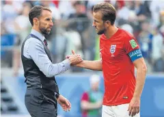  ?? AFP ?? England manager Gareth Southgate shakes hands with team captain Harry Kane.