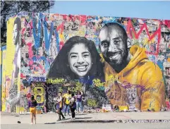  ?? PHOTO: REUTERS ?? Fans gather around a mural of late NBA great Kobe Bryant and daughter Gianna, who were killed, along with seven others, when a helicopter crashed near Los Angeles on this day last year.