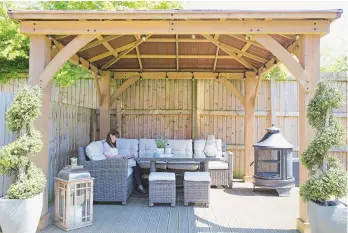  ??  ?? garden a large gazebo with comfy seating has transforme­d the outdoor space. yardistry cedar gazebo, £999.99, costco. azores sofa and corner lounge set, £1,199, christophe­r Pratts, would work here