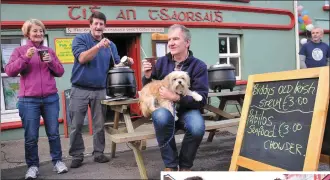  ?? Photos by Declan Malone ?? ABOVE, LEFT: Linda Ní hAiniféin with a selection of her Contempora­ry Irish Ceramics at Féile an Bhuailtín on Sunday.ABOVE, RIGHT: Diarmaid Mac an tSaoir dishing up ‘Biddy’s Old Irish Stew’ to Mary Reilly and Gary Granville, along with Dude the dog. RIGHT: Diana Rowe, Breege Granville and Paula Casey with some of the cast of Star Wars characters, knitted by Paula.