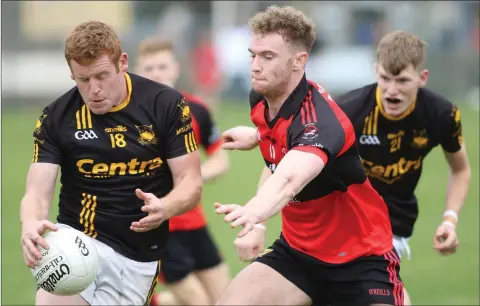  ??  ?? Ian Bradley of Adamstown under pressure from Bannow-Ballymitty’s Mark Wallace.