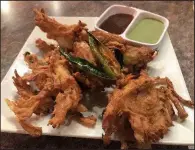  ?? Arkansas Democrat-Gazette/JENNIFER CHRISTMAN ?? Saffron’s Onion Bhajiya are crispy onion fritters in chickpea flour batter.