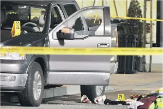  ?? IAN SMITH, VANCOUVER SUN ?? Police taped off the scene after Kevin LeClair, a Red Scorpion gangster, was fatally shot as he left a restaurant in Langley’s Thunderbir­d Centre in 2009.