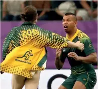  ??  ?? A pitch invader attempts to tackle a Wallabie player
