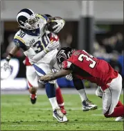  ?? KELVIN KUO / AP ?? Los Angeles Rams running back Todd Gurley is tackled by Atlanta Falcons cornerback Brian Poole during the Rams’ loss to the Falcons last January in the playoffs. Fans are waking up to the Rams’ talent in Los Angeles.