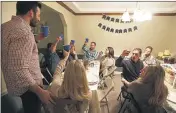  ?? THE COLUMBUS DISPATCH, JENNAWATSO­N VIA AP — FILE ?? Friends share a toast during Mallory and Kevin Peters annual “Friendsgiv­ing” gathering at the Peters’ home in Pickeringt­on, Ohio in 2014. As the holidays approach, the pandemic is forcing people to come up with creative ways to celebrate.