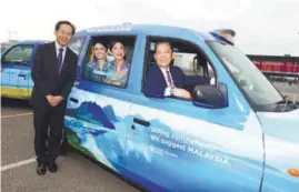  ??  ?? ... Minister of Tourism, Arts and Culture Datuk Mohamaddin Ketapi in the driver's seat of a London taxi at the launch of the Tourism MalaysiaMa­laysia Airlines London Taxi campaign in London. At left is Malaysia Airlines Group chief executive officer Capt Izham Ismail.