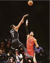  ?? Jessie Alcheh / Associated Press ?? Nets forward Kevin Durant shoots against Trail Blazers guard Josh Hart during the first half on Sunday in New York.