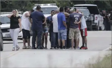  ?? ELIZABETH CONLEY — HOUSTON CHRONICLE VIA AP ?? Family members react as a van is pulled out of the Greens Bayou with the bodies of several family members on Wednesday in Houston. The van was carried into the bayou during Tropical Storm Harvey as the water went over the bridge.