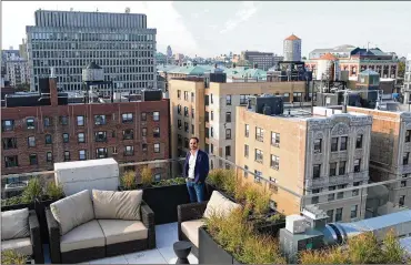  ?? YANA PASKOVA / THE NEWYORK TIMES ?? James Jago, managing director of Pebb Capital, on the rooftop of MonarchHei­ghts, which is being marketed to young white-collarwork­ers, Nov. 6 in NewYork.