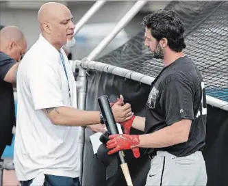  ?? CHRIS O'MEARA THE ASSOCIATED PRESS ?? Tony Clark, left, head of the Major League Baseball Players Associatio­n, shakes hands with free agent player and former Toronto Blue Jay Chris Colabello before an exhibition baseball game in Bradenton, Fla.