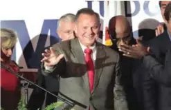  ?? —AFP ?? MONTGOMERY: Republican candidate for the US Senate in Alabama, Roy Moore (R) greets supporters at an election-night rally.