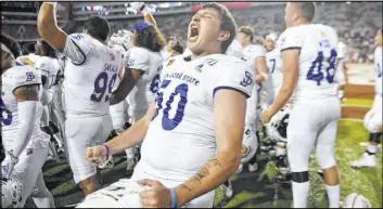  ?? Michael Woods The Associated Press ?? San Jose State long snapper Will Butler whoops it up with his teammates after defeating SEC school Arkansas 31-24 in a nonconfere­nce game Sept. 21, 2019, in Fayettevil­le, Ark.