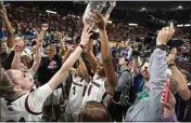  ?? MIC SMITH / AP ?? South Carolina’s Aliyah Boston holds up the championsh­ip trophy after defeating Tennessee 74-58 to win the Southeaste­rn Conference women’s tournament in Greenville, S.C., on March 5.