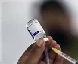  ?? Marco Ugarte/Associated Press ?? A health worker prepares to administer a dose of the AstraZenec­a COVID-19 vaccine during a vaccinatio­n drive for people ages 30 to 39 in Mexico City on July 7.