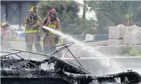  ?? AMY BETH BENNETT/SOUTH FLORIDA SUN SENTINEL ?? Firefighte­rs work to put out a fire on a boat on the New River in Fort Lauderdale on Thursday. Authoritie­s said 13 people have burn injuries after the 41-foot pleasure boat exploded and caught fire.
