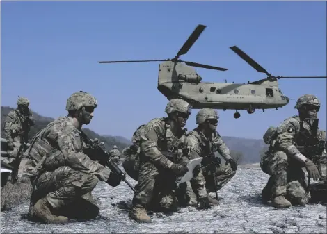  ?? AP PHOTO/AHN YOUNG-JOON ?? U.S. Army soldiers wait to board their CH-47 Chinook helicopter during a joint military drill between South Korea and the United States at Rodriguez Live Fire Complex in Pocheon, South Korea, on Sunday.