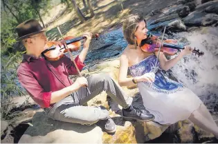  ?? COURTESY OF RON HALE ?? Santa Fe based 44% Dandelion pays tribute to fiddle traditions from around the world. The duo, made up of Doug Goodhart and Karina Wilson, is part of the Santa Fe Traditiona­l Music Festival this weekend.