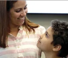  ??  ?? Lidia Karine Souza and her son Diogo De Olivera Filho smile at each other at the Mayer Brown law firm during a news conference shortly after Diogo was reunited with his mother Thursday in Chicago. AP PHOTO/CHARLES REX ARBOGAST