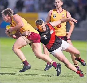  ??  ?? Kyabram’s Brad Edwards clings on to Shepparton’s Matt Ryan during Saturday night’s match. Picture: Rodney Braithwait­e.