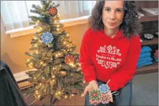  ?? CAROLE MORRIS-UNDERHILL ?? Ginger LeBoutilli­er shows off the three holiday ornaments she will be showing people how to create during a special Christmas Angels fundraiser Nov. 28. The ornaments feature either a Kwanzaa, Hanukkah or Christmas mandala pattern.