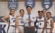  ?? DISNEY+ ?? John Stamos, center, returns to series television as a men’s basketball coach who signs with an elite girls private school team after getting fired from the NCAA in “Big Shot.”