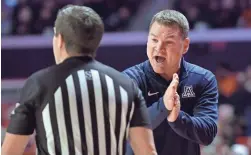  ?? RON JOHNSON/USA TODAY SPORTS ?? Arizona head coach Tommy Lloyd talks with an official during the first half Saturday against Illinois at State Farm Center.