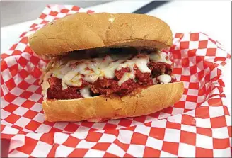  ?? ALEX HORVATH / THE CALIFORNIA­N ?? House-made meatballs with fresh tomato sauce are topped with shredded mozzarella cheese for a sandwich at Mamma Mia Panini Italian Deli.