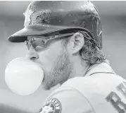  ?? Carlos Orsorio / Associated Press ?? Astros outfielder Josh Reddick was working the bubble gum early in Saturday’s game at Detroit.