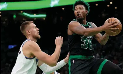  ?? ?? Kristaps Porzingis, left, and Marcus Smart will be moving teams as part of the deal. Photograph: Steven Senne/AP