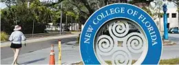  ?? CHRIS O’MEARA/AP ?? A student makes her way past the sign at New College on Jan. 20 in Sarasota.