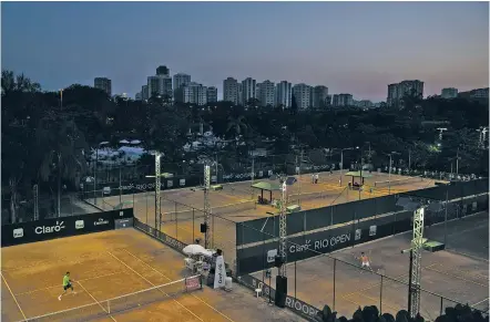  ?? FELIPE DANA/THE ASSOCIATED PRESS ?? Tennis players practice Thursday at the Rio Open tennis tournament in Rio de Janeiro. The days of clay-court tennis in Latin America are numbered. The clay-court circuit lost a major event several years ago when this week’s Mexican Open in Acapulco...